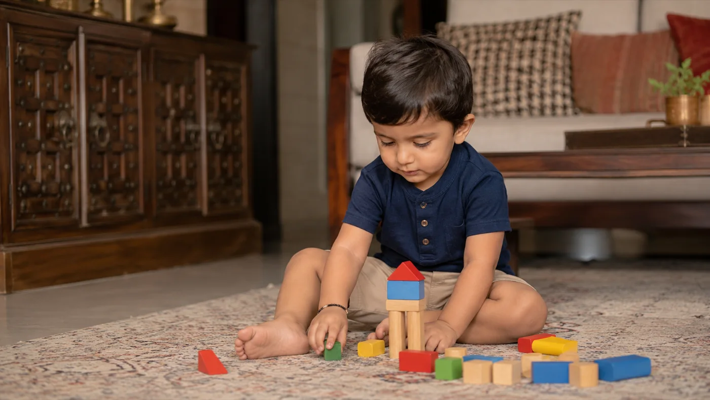 A toddler building with wooden blocks